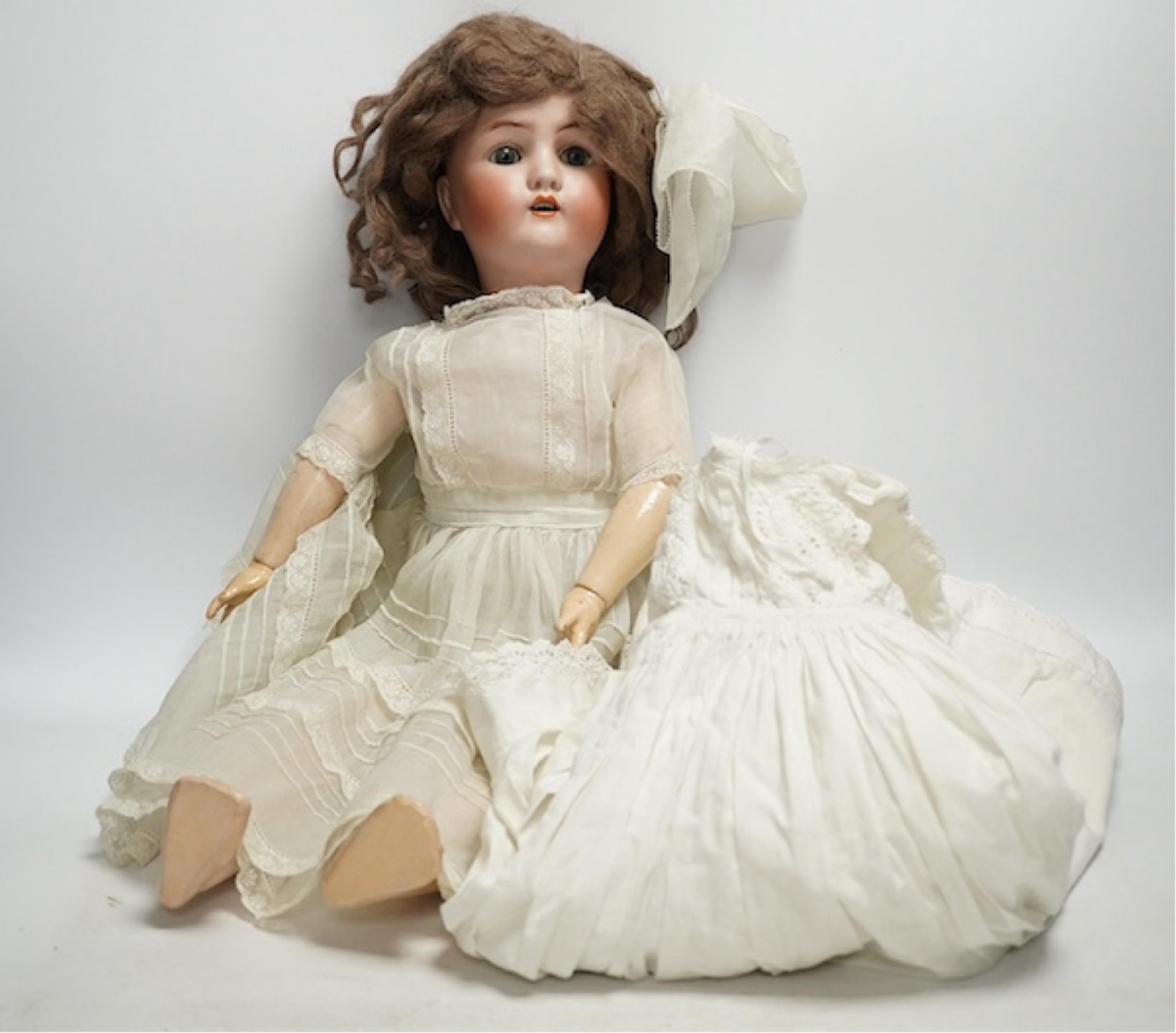 An Alt Beck & Gottschalk bisque doll and three baby dresses, 61cm high. Condition - fair